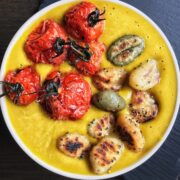 Pumpkin soup with gnocchi and roasted tomatoes in a bowl