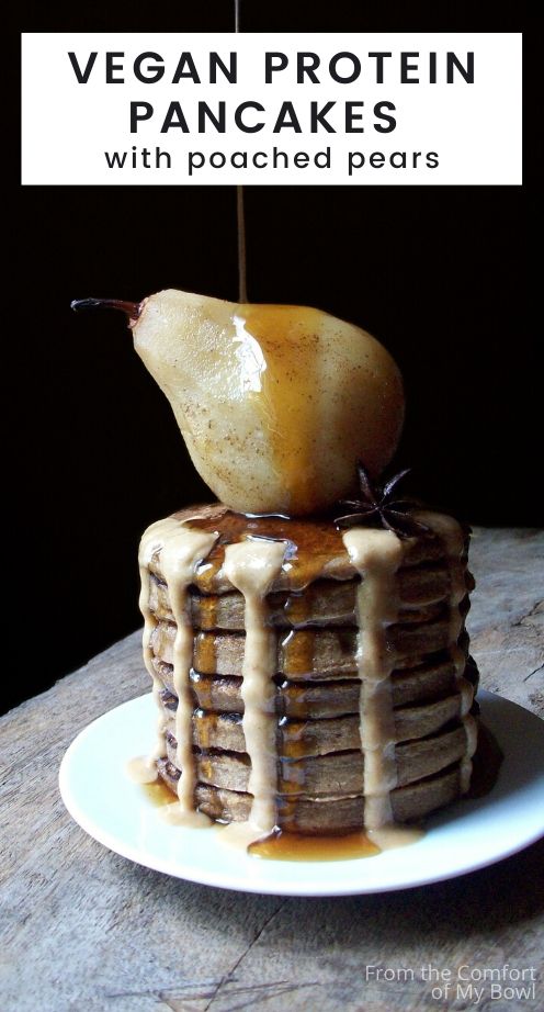 Stack of vegan pancakes with poached pears, maple syrup and hazelnut butter on a plate