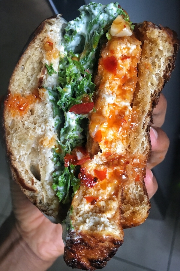 Vegan buffalo chicken sandwich with kale and ranch