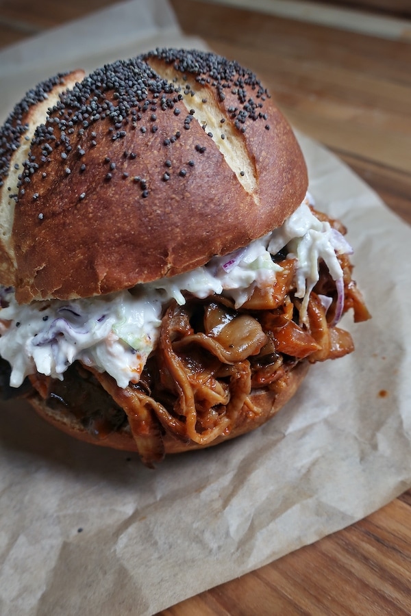vegan pulled pork sandwich with mushroom on parchment paper