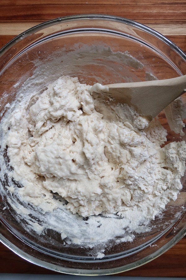 Flour with wooden spoon in a bowl
