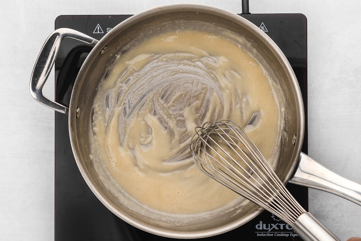 Flour and butter in pan with whisk
