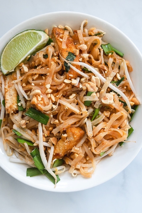 Pad thai with lime wedge in a bowl