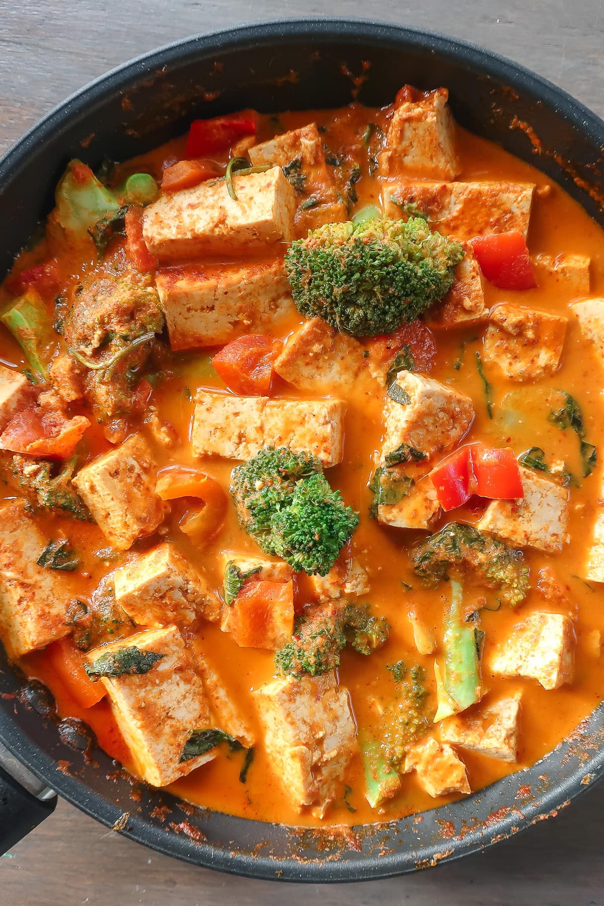 thai red curry with tofu and vegetables in a pan