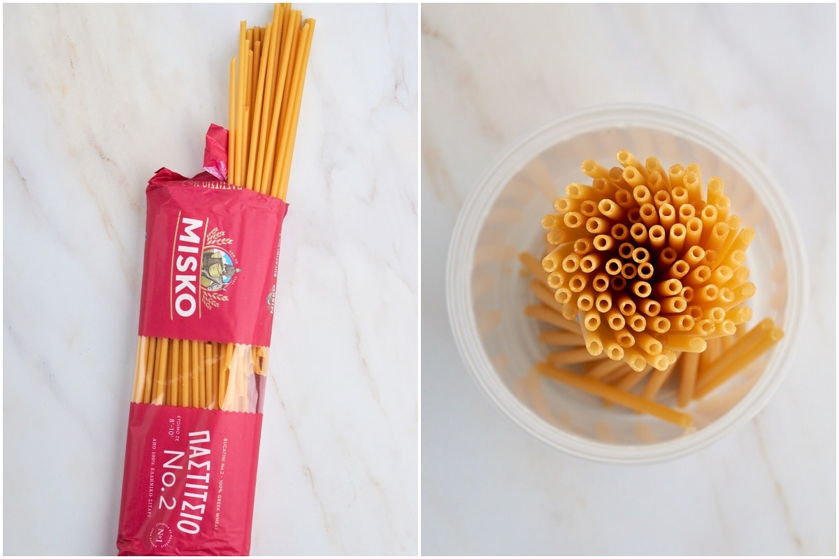 Uncooked bucatini pasta in plastic cup.